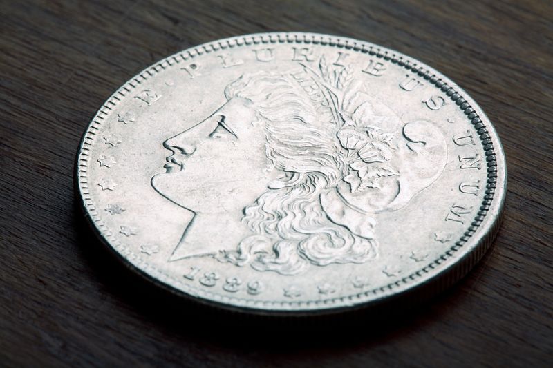 1889 Morgan Silver Dollar obverse on a wood table